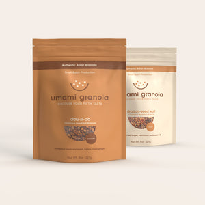 Two packages of umami granola on a white background