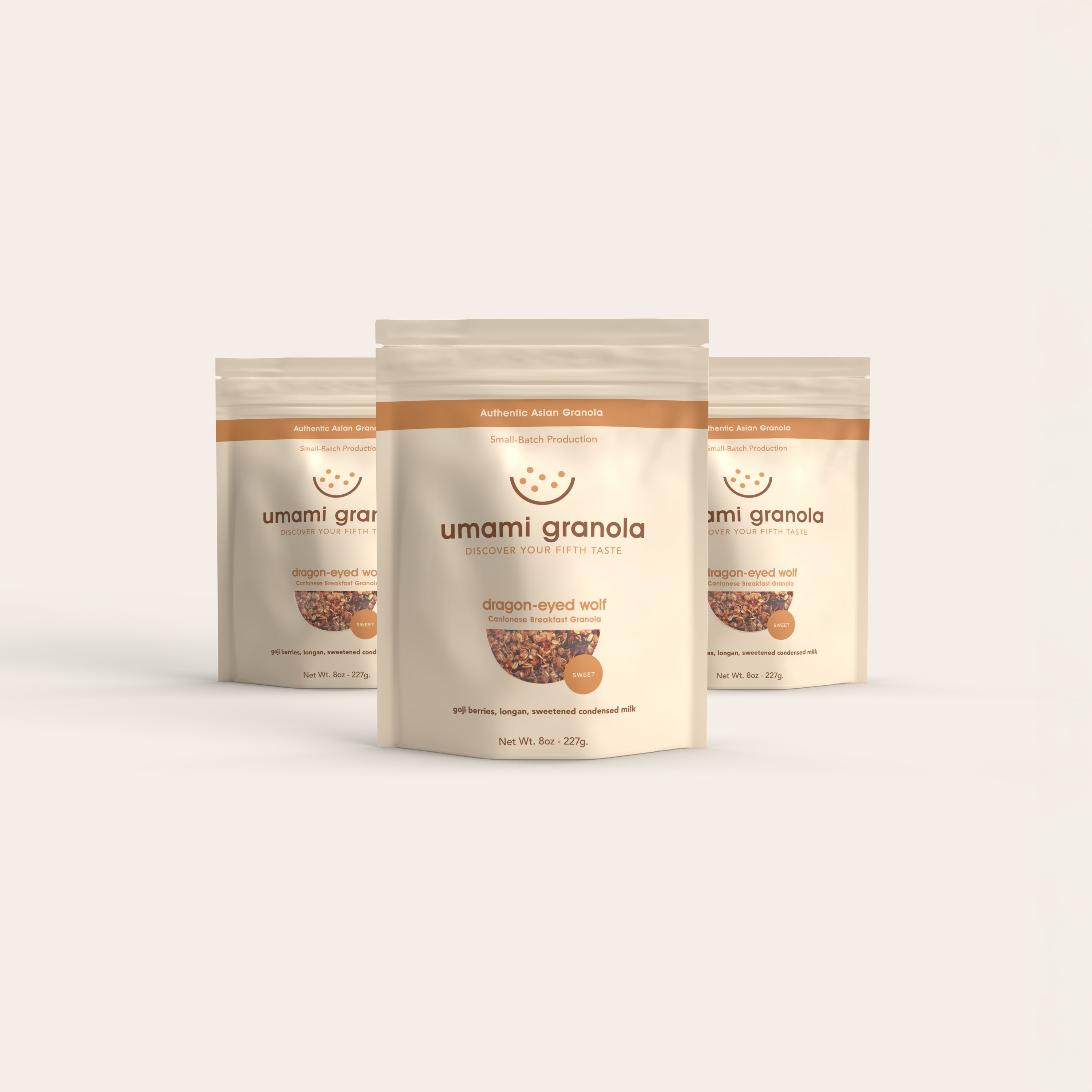 Three packages of umami granola on a light beige background